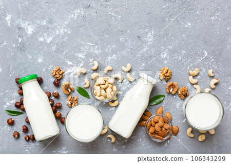Set or collection of various vegan milk almond, cashew, on table background. Vegan plant based milk and ingredients, top view Set or collection of various vegan milk almond, cashew, on table background. Vegan plant based milk and ingredients, top view 106343299