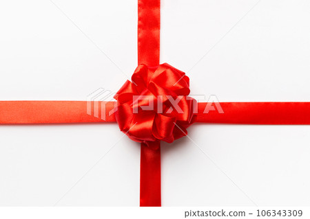 Top view of Red ribbon rolled and red bow isolated on colored background. Flat lay with copy space 106343309