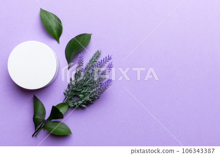 Organic cosmetic products with lavander flower and green leaves on color background. Copy space, flat lay Organic cosmetic products with lavander flower and green leaves on color background. Copy space, flat lay 106343387