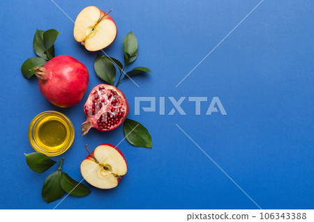 Flat lay composition with symbols jewish Rosh Hashanah holiday attributes on colored background, Rosh hashanah concept. New Year holiday Traditional. Top view with copy space Flat lay composition with symbols jewish Rosh Hashanah holiday attributes on colored background, Rosh hashanah concept. New Year holiday Traditional. Top view with copy space 106343388