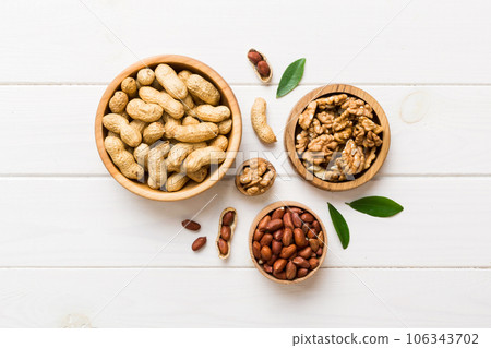 Walnut kernel halves, in a wooden bowl. Close-up, from above on colored background. Healthy eating Walnut concept. Super foods with copy space Walnut kernel halves, in a wooden bowl. Close-up, from above on colored background. Healthy eating Walnut concept. Super foods with copy space 106343702