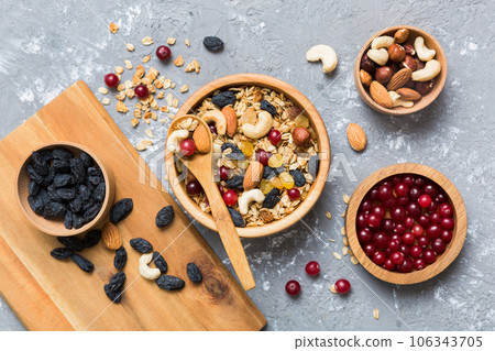 Cooking a wholesome breakfast. Granola with Various dried fruits and nuts in a bowl. The concept of a healthy dessert. Flat lay, top view with copy space 106343705