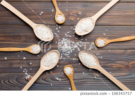 salt on many wooden spoon on wood background. Spoons with different salt 106343757