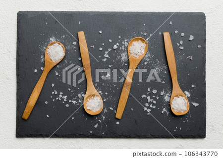 salt on many wooden spoon on wood background. Spoons with different salt 106343770