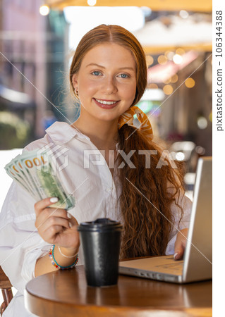 Happy rich girl counting money dollar cash menu app ordering food, delivery online in city cafeteria Happy rich girl counting money dollar cash menu app ordering food, delivery online in city cafeteria 106344388
