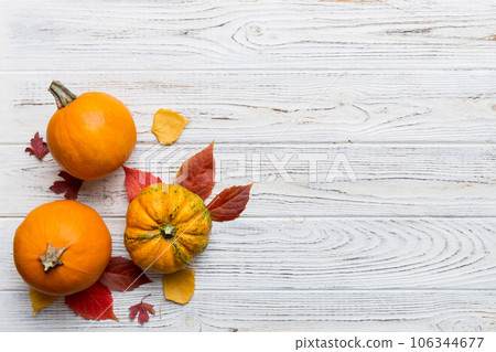 Autumn composition. Pattern made of dried leaves and other design accessories on table. Flat lay, top view Autumn composition. Pattern made of dried leaves and other design accessories on table. Flat lay, top view 106344677