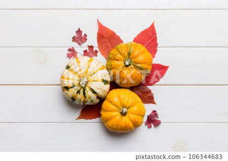 Autumn composition. Pattern made of dried leaves and other design accessories on table. Flat lay, top view 106344683