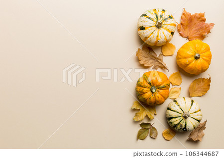 Autumn composition. Pattern made of dried leaves and other design accessories on table. Flat lay, top view Autumn composition. Pattern made of dried leaves and other design accessories on table. Flat lay, top view 106344687