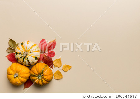 Autumn composition. Pattern made of dried leaves and other design accessories on table. Flat lay, top view Autumn composition. Pattern made of dried leaves and other design accessories on table. Flat lay, top view 106344688