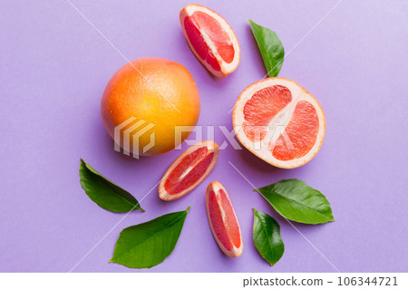 fresh Fruit grapefruit with Juicy grapefruit slices on colored background. Top view. Copy Space. creative summer concept. Half of citrus in minimal flat lay with copy space fresh Fruit grapefruit with Juicy grapefruit slices on colored background. Top view. Copy Space. creative summer concept. Half of citrus in minimal flat lay with copy space 106344721