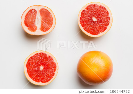 fresh Fruit grapefruit with Juicy grapefruit slices on colored background. Top view. Copy Space. creative summer concept. Half of citrus in minimal flat lay with copy space fresh Fruit grapefruit with Juicy grapefruit slices on colored background. Top view. Copy Space. creative summer concept. Half of citrus in minimal flat lay with copy space 106344732