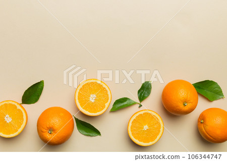 fresh Fruit orange slices on colored background. Top view. Copy Space. creative summer concept. Half of citrus in minimal flat lay with copy space fresh Fruit orange slices on colored background. Top view. Copy Space. creative summer concept. Half of citrus in minimal flat lay with copy space 106344747
