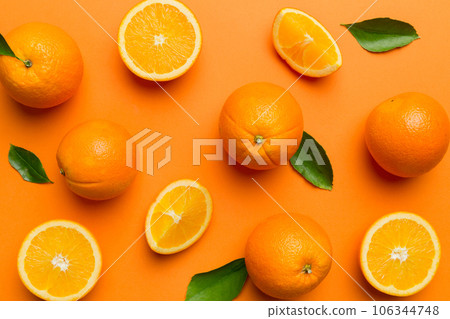 Fruit pattern of fresh orange slices on colored background. Top view. Copy Space. creative summer concept. Half of citrus in minimal flat lay Fruit pattern of fresh orange slices on colored background. Top view. Copy Space. creative summer concept. Half of citrus in minimal flat lay 106344748