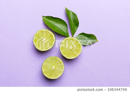 Lime fruits with green leaf and cut in half slice isolated on white background. Top view. Flat lay with copy space Lime fruits with green leaf and cut in half slice isolated on white background. Top view. Flat lay with copy space 106344749