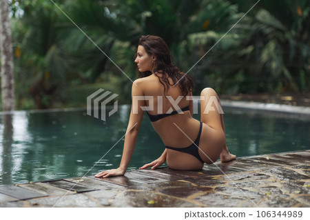 Sad Bikini Beach Girl Poolside on Rainy Day Tropical Vacation Sad Bikini Beach Girl Poolside on Rainy Day Tropical Vacation 106344989