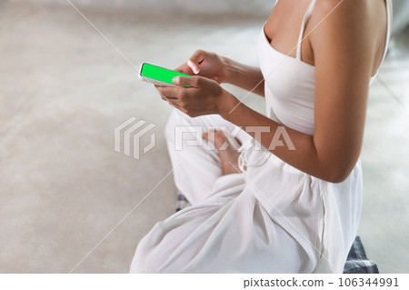 Meditation App Close-Up, Woman's Hands with Smartphone During Yoga Meditation App Close-Up, Woman's Hands with Smartphone During Yoga 106344991