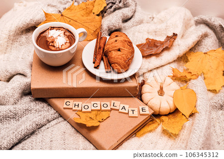Autumn composition book, croissant, coffee, leaves and pumpkin Autumn composition book, croissant, coffee, leaves and pumpkin 106345312