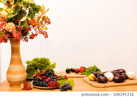 Autumn composition of fruits and vegetables on the table on a white background Autumn composition of fruits and vegetables on the table on a white background 106345338
