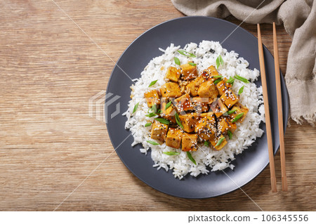 plate of rice and fried tofu with sesame seeds, top view 106345556