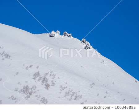 A rocky surface slightly peeking out from a snow-covered mountain (Hokkaido, Kutchan-cho, Iwaonupuri area) A rocky surface slightly peeking out from a snow-covered mountain (Hokkaido, Kutchan-cho, Iwaonupuri area) 106345882