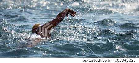 Man swimmer swimming crawl in blue sea, training for triathlon 106346223