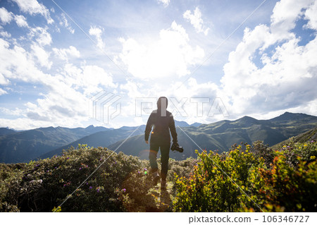 Woman photographer walking in summer high altitude mountains, China Woman photographer walking in summer high altitude mountains, China 106346727
