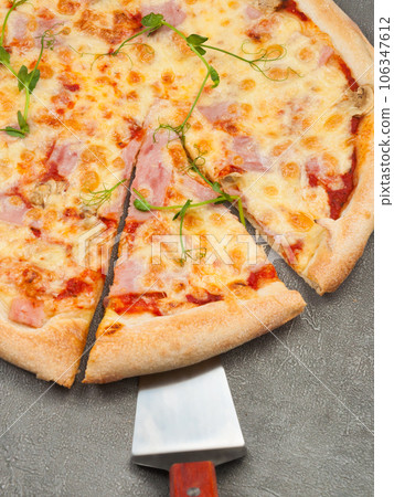 american pizza with ham and mozzarella on a gray background american pizza with ham and mozzarella on a gray background 106347612