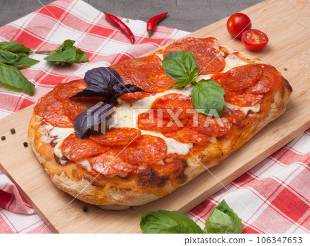 italian tomato-based pizza with mozzarella and pepperoni 106347653