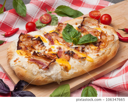 italian pizza with bacon, mozzarella and cheese sauce 106347665