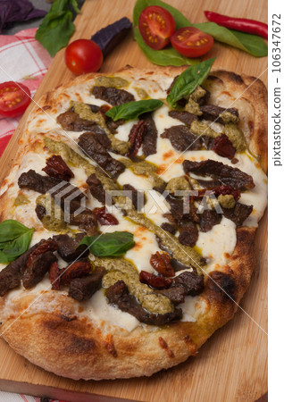 italian pizza with beef, mozzarella and pesto italian pizza with beef, mozzarella and pesto 106347672