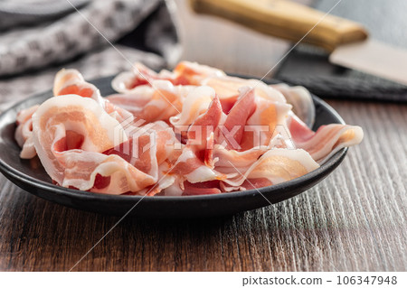 Italian panchetta. Sliced smoked bacon on plate. Italian panchetta. Sliced smoked bacon on plate. 106347948
