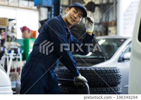 Mechanic servicing a car 106348204