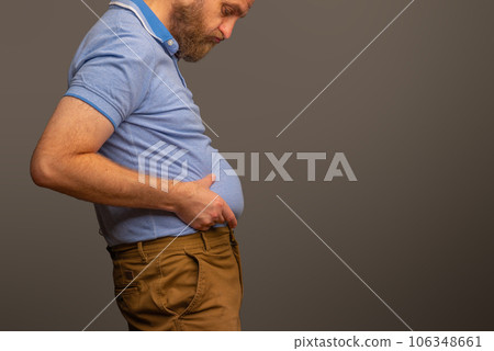 Overweight man in t-shirt on grey background, closeup. Space for text Overweight man in t-shirt on grey background, closeup. Space for text 106348661