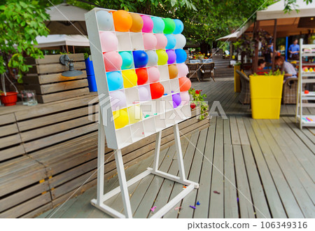 Shooting range with colorful inflatable balls in a cafe or park. Shooting range with colorful inflatable balls in a cafe or park. 106349316