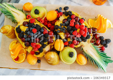 Beautiful and original serving of fruits and berries in pineapple. Beautiful and original serving of fruits and berries in pineapple. 106349317