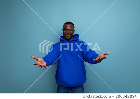 young black american man in casual wear with open arms on studio background with copy space 106349854