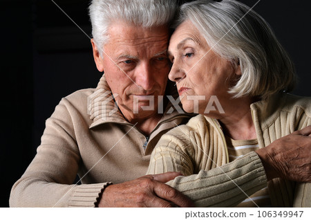 Close up portrait of sad senior couple posing at home 106349947