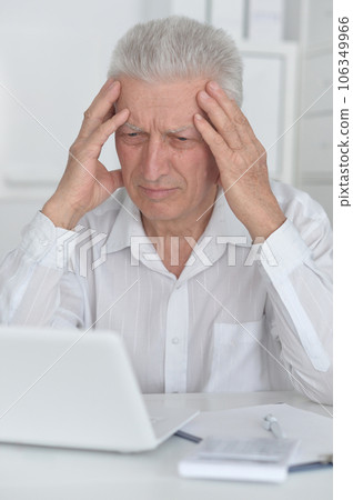 Senior businessman working with his laptop at office 106349966