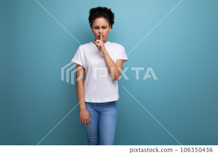 beautiful young swarthy woman with porous curly hair, dressed in a white T-shirt without a pattern beautiful young swarthy woman with porous curly hair, dressed in a white T-shirt without a pattern 106350436
