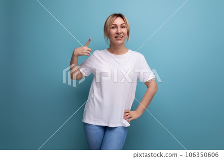 blond young lady in white tank top for business logo print on studio background with copy space blond young lady in white tank top for business logo print on studio background with copy space 106350606