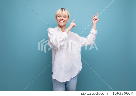 cheerful young blond business woman in a white shirt reports interesting news on the background with 106350667