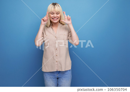 kind pleasant blond young caucasian woman in casual clothes with emotions of joy kind pleasant blond young caucasian woman in casual clothes with emotions of joy 106350704