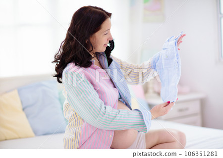 Pregnant woman at home. Young expecting mother. 106351281