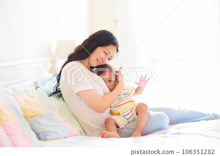 Mother nursing baby at home. Breastfeeding infant. 106351282