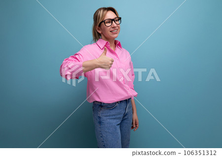 young successful caucasian blond office worker woman dressed in a pink shirt and jeans and glasses young successful caucasian blond office worker woman dressed in a pink shirt and jeans and glasses 106351312