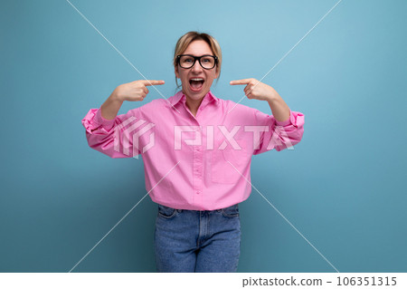 young positive well-groomed caucasian blond office worker woman dressed in pink shirt and jeans and 106351315