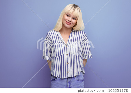 smiling blond 25 year old female person in striped blouse and jeans posing as a model smiling blond 25 year old female person in striped blouse and jeans posing as a model 106351378