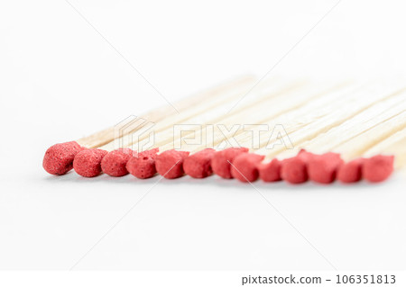 Matches in a row Standing out from the crowd concept. Match stick on white. Matches in a row Standing out from the crowd concept. Match stick on white. 106351813
