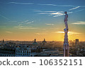 Sunset over city of Milan. Shades of orange, pink, and purple spread across the sky 106352151