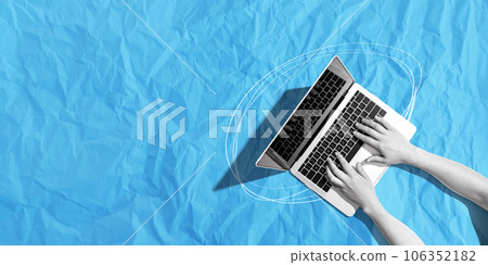Person using a laptop computer with crumpled paper texture 106352182